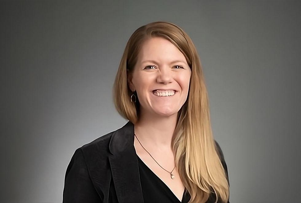 A veterinarian smiles in a professional headshot photo.