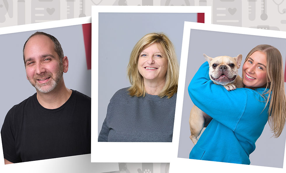 Three VEG employees smile for the camera, one holds a white dog. 