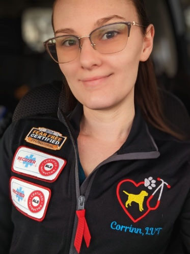 Veterinary nurse smiling wearing glasses and work scrubs