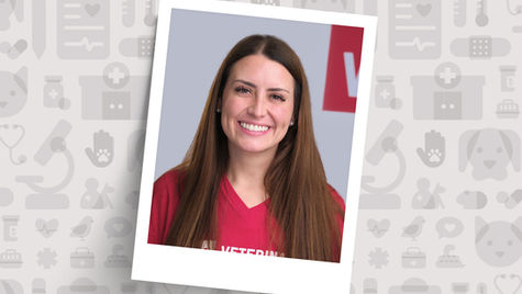 Veterinary nursing manager in red shirt smiles in poloroid picture against a gray and white animal print background.