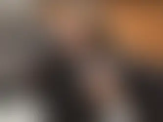 An black dog is at the vet being checked for obesity. 