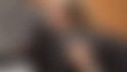 An black dog is at the vet being checked for obesity. 