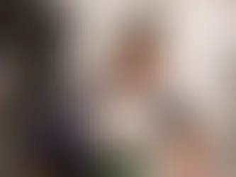 A vet hospital employee treats a white dog.