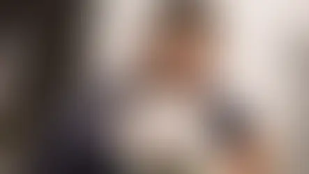 A vet hospital employee treats a white dog.