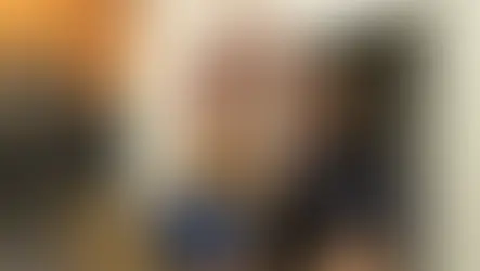 Golden fur dog looking up at veterinarian