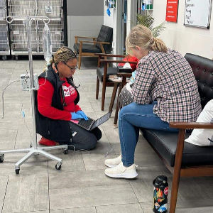 Image of a vet tech talking to a patient's owner