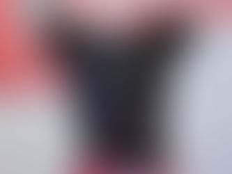 A black dog with a spider bite looks into the camera