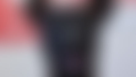 A black dog with a spider bite looks into the camera
