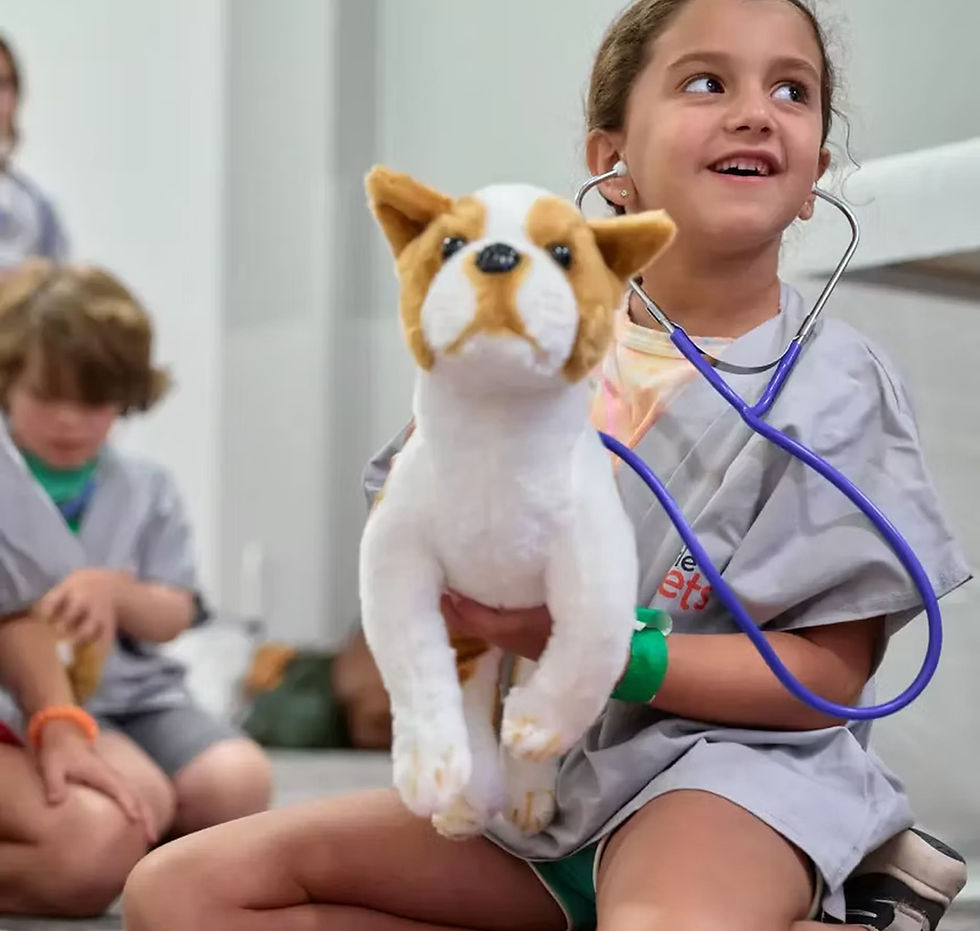 A little girl uses a stethoscope on a toy dog